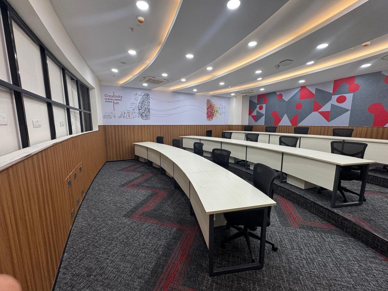 Curved briefing room desks with runway-motif accent wall